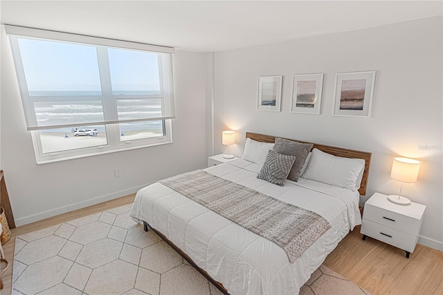 705 N Atlantic Ave Unit 4030, New Smyrna Beach, FL 32169 - bedroom featuring baseboards and light wood-style floors