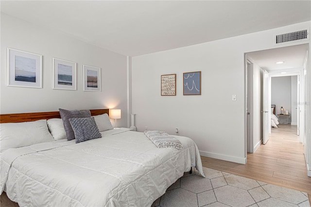 705 N Atlantic Ave Unit 4030, New Smyrna Beach, FL 32169 - bedroom featuring light wood finished floors, visible vents, and baseboards