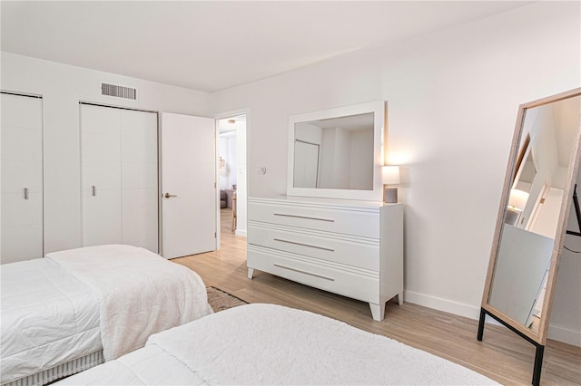 705 N Atlantic Ave Unit 4030, New Smyrna Beach, FL 32169 - bedroom with visible vents, multiple closets, light wood finished floors, and baseboards