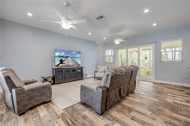 living room featuring wood finished floors, a ceiling fan, visible vents, and recessed lighting