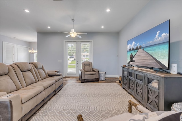 living room featuring wood finished floors, ceiling fan with notable chandelier, baseboards, and recessed lighting