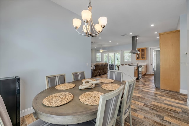 dining room with baseboards, recessed lighting, a chandelier, and wood finished floors