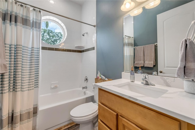 full bathroom with shower / bathtub combination with curtain, vanity, and toilet