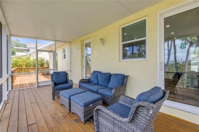 wooden deck with an outdoor living space