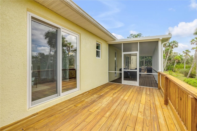 wooden deck with a sunroom