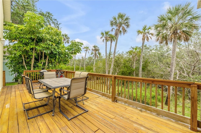 wooden terrace with outdoor dining area