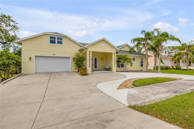 view of front of property with concrete driveway, a garage, and stucco siding