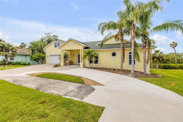 view of front facade with concrete driveway, an attached garage, and a front lawn