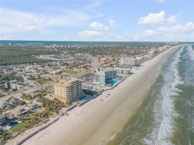 bird's eye view with a water view, a view of city, and a view of the beach