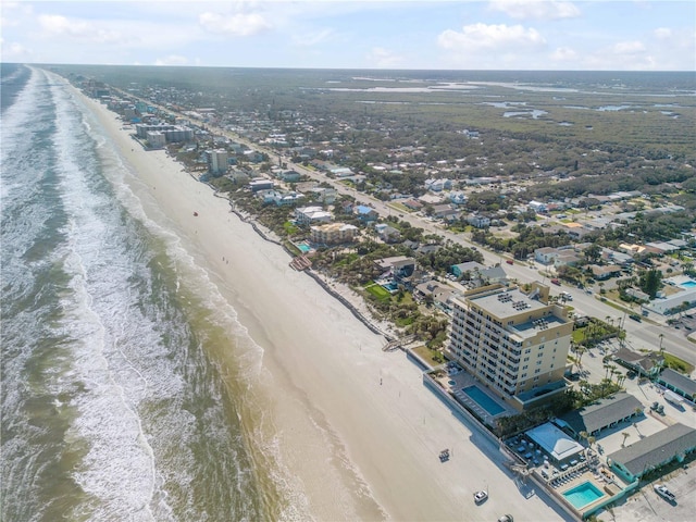 bird's eye view with a water view and a beach view