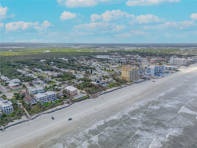 bird's eye view featuring a water view, a beach view, and a city view