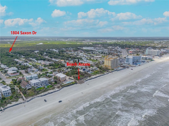 aerial view featuring a water view, a view of city, and a beach view