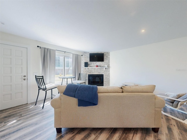 4752 S Atlantic Ave Unit 1, Ponce Inlet, FL 32127 - living area featuring a stone fireplace and wood finished floors
