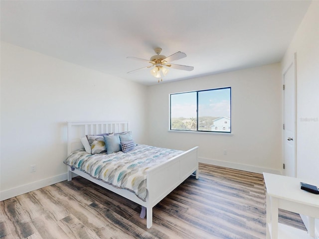 4752 S Atlantic Ave Unit 1, Ponce Inlet, FL 32127 - bedroom with wood finished floors, baseboards, and ceiling fan