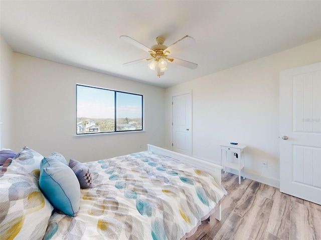 4752 S Atlantic Ave Unit 1, Ponce Inlet, FL 32127 - bedroom featuring light wood-style flooring, a ceiling fan, and baseboards