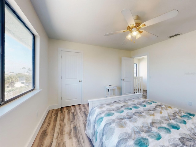 4752 S Atlantic Ave Unit 1, Ponce Inlet, FL 32127 - bedroom featuring light wood-type flooring, ceiling fan, and baseboards