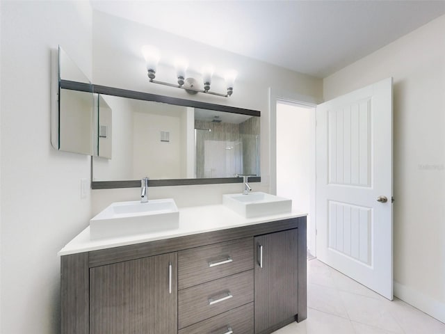 4752 S Atlantic Ave Unit 1, Ponce Inlet, FL 32127 - full bathroom featuring double vanity, a shower with door, tile patterned floors, and baseboards