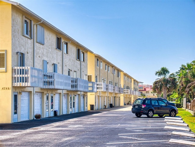 4752 S Atlantic Ave Unit 1, Ponce Inlet, FL 32127 - view of building exterior with uncovered parking and a residential view