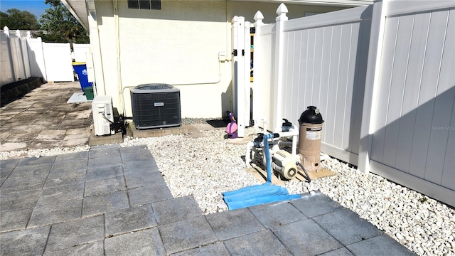 exterior details featuring fence and central AC unit