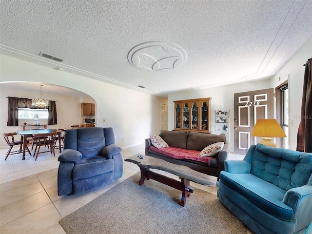 2218 Orange Tree Dr, Edgewater, FL 32141 - living room featuring arched walkways, a textured ceiling, visible vents, and light tile patterned flooring