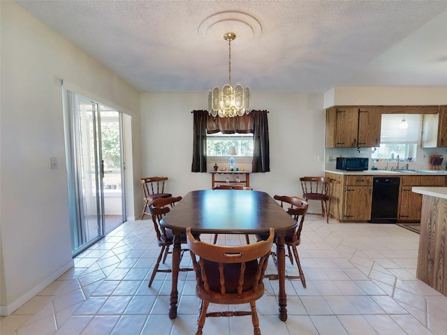 2218 Orange Tree Dr, Edgewater, FL 32141 - dining space with a notable chandelier, a textured ceiling, and light tile patterned floors