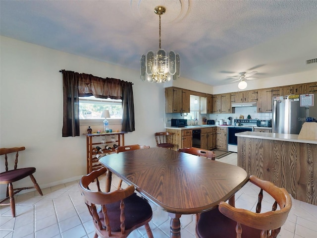 2218 Orange Tree Dr, Edgewater, FL 32141 - dining space with light tile patterned floors, baseboards, visible vents, and ceiling fan with notable chandelier