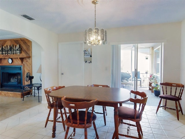 2218 Orange Tree Dr, Edgewater, FL 32141 - dining room featuring arched walkways, a notable chandelier, visible vents, and a fireplace