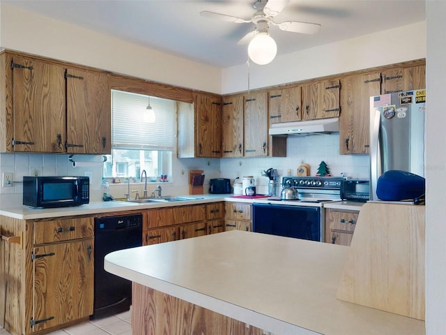 2218 Orange Tree Dr, Edgewater, FL 32141 - kitchen featuring black appliances, brown cabinets, under cabinet range hood, and a sink