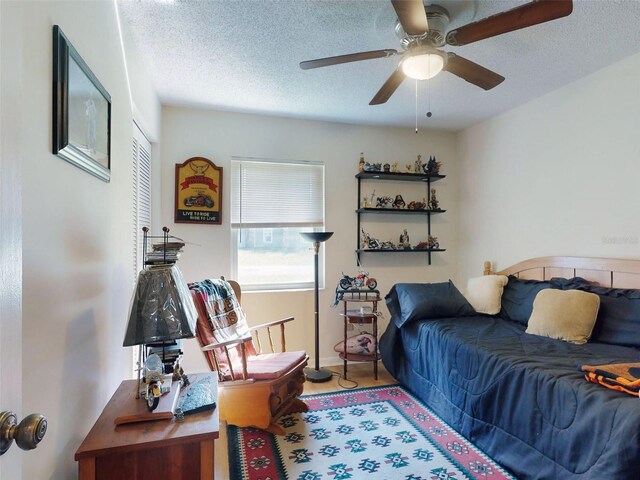 2218 Orange Tree Dr, Edgewater, FL 32141 - bedroom with a ceiling fan, a textured ceiling, and a closet