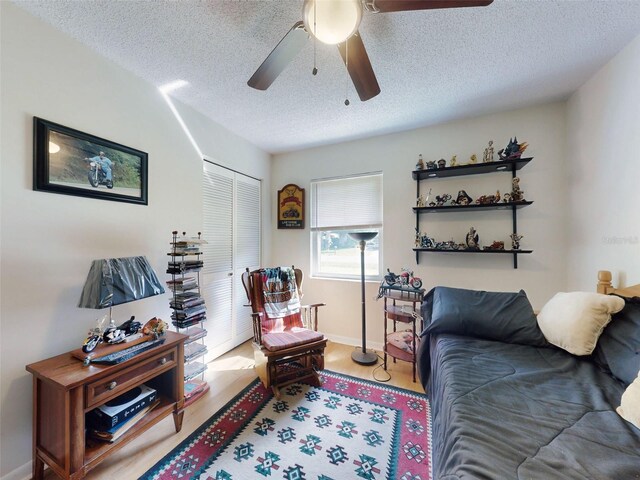 2218 Orange Tree Dr, Edgewater, FL 32141 - interior space featuring a ceiling fan, baseboards, a textured ceiling, and light wood-style flooring