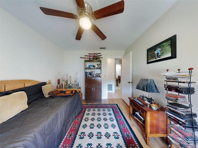 2218 Orange Tree Dr, Edgewater, FL 32141 - bedroom featuring visible vents, a ceiling fan, wood finished floors, and a textured ceiling