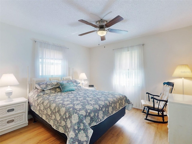 2218 Orange Tree Dr, Edgewater, FL 32141 - bedroom featuring light wood-style flooring, a textured ceiling, and a ceiling fan