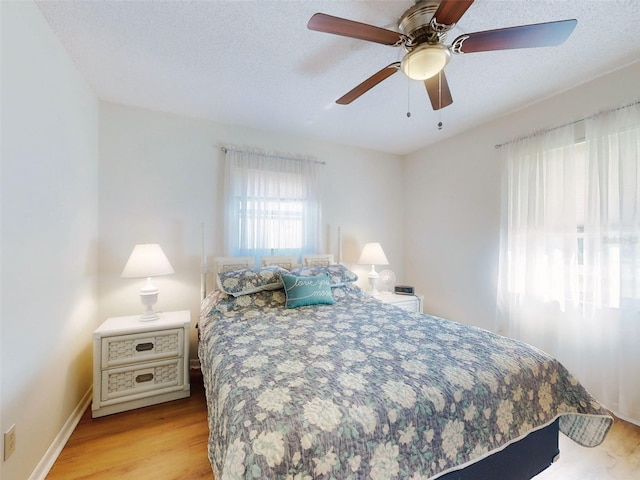 2218 Orange Tree Dr, Edgewater, FL 32141 - bedroom with ceiling fan, baseboards, and light wood-style floors
