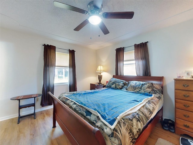 2218 Orange Tree Dr, Edgewater, FL 32141 - bedroom featuring baseboards, a ceiling fan, multiple windows, and light wood-style flooring
