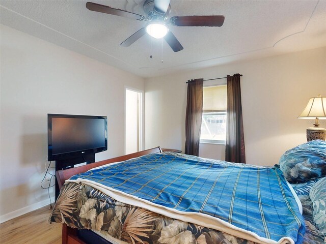 2218 Orange Tree Dr, Edgewater, FL 32141 - bedroom with baseboards, a ceiling fan, and wood finished floors