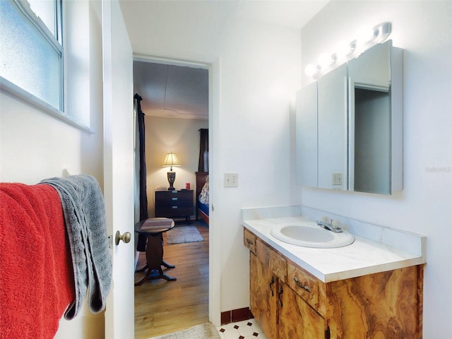 2218 Orange Tree Dr, Edgewater, FL 32141 - bathroom with connected bathroom, vanity, and wood finished floors