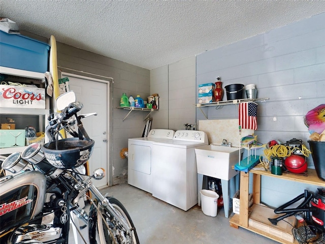 2218 Orange Tree Dr, Edgewater, FL 32141 - laundry room with concrete block wall, washing machine and dryer, a textured ceiling, and laundry area