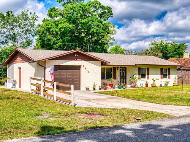 2218 Orange Tree Dr, Edgewater, FL 32141 - ranch-style home with stucco siding, an attached garage, driveway, and fence