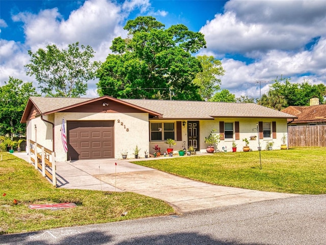 2218 Orange Tree Dr, Edgewater, FL 32141 - single story home featuring a front lawn, driveway, fence, a garage, and stucco siding