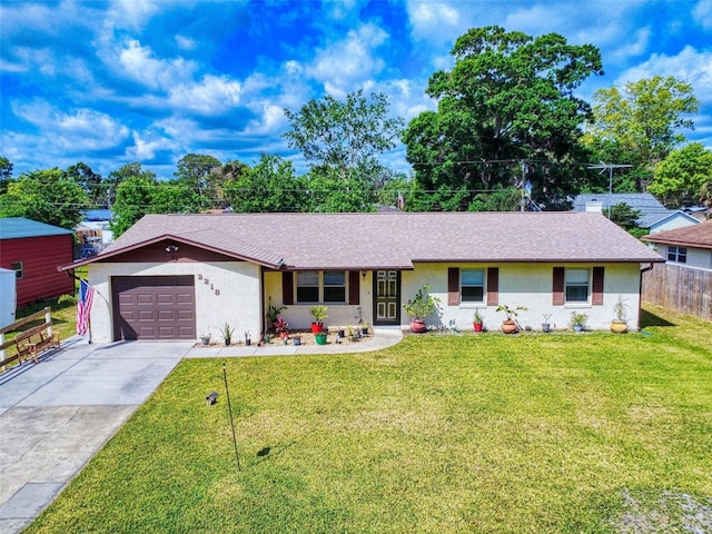 2218 Orange Tree Dr, Edgewater, FL 32141 - single story home featuring a front lawn, driveway, an attached garage, fence, and stucco siding