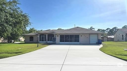 2530 Tamarind Dr, Edgewater, FL 32141 - ranch-style home with a garage, a front lawn, and driveway