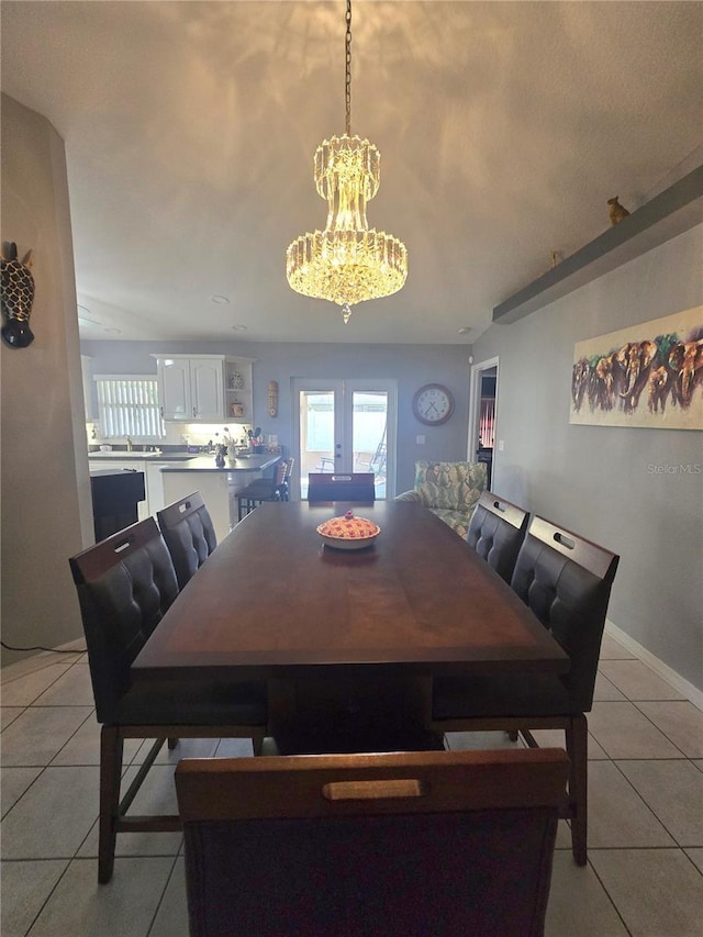 2530 Tamarind Dr, Edgewater, FL 32141 - dining room featuring light tile patterned floors, a chandelier, and baseboards