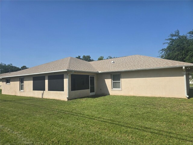 2530 Tamarind Dr, Edgewater, FL 32141 - rear view of property with a yard and stucco siding