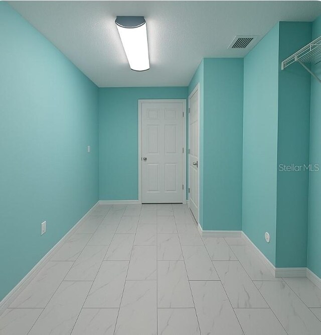 2530 Tamarind Dr, Edgewater, FL 32141 - spare room featuring light marble finish flooring and baseboards