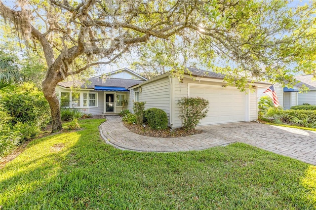 606 Saint Andrews Blvd, New Smyrna Beach, FL 32168 - view of front facade with a garage, a front yard, and decorative driveway