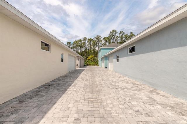 view of property exterior featuring stucco siding and decorative driveway
