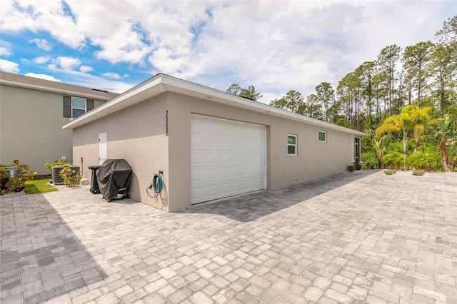 garage featuring decorative driveway