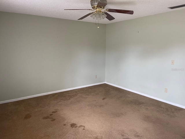 3048 Unity Tree Dr, Edgewater, FL 32141 - empty room featuring a textured ceiling, dark colored carpet, and a ceiling fan