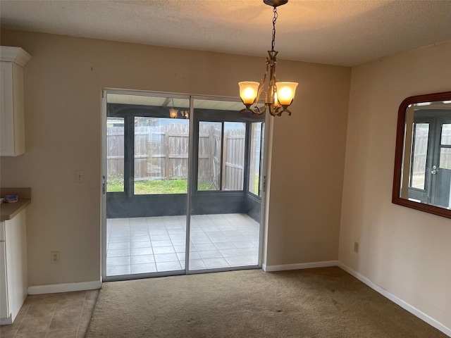 3048 Unity Tree Dr, Edgewater, FL 32141 - unfurnished dining area featuring carpet flooring, a textured ceiling, baseboards, and a notable chandelier