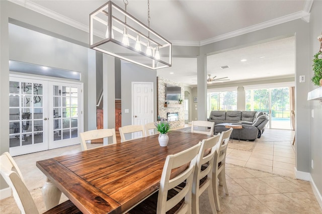 495 Venetian Villa Dr, New Smyrna Beach, FL 32168 - dining room with light tile patterned floors, baseboards, crown molding, and ceiling fan